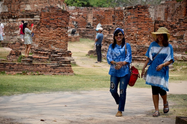 People travel and walking around ancient building at Wat Mahathat on February 29 2016 in Ayutthaya Thailand