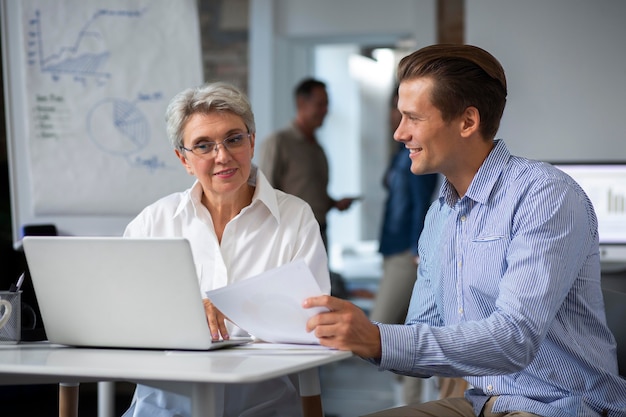 People using digital device while in a meeting