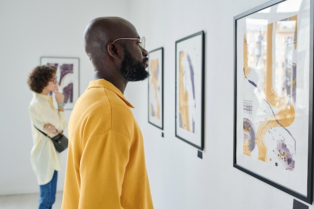 People visiting art exhibition at gallery