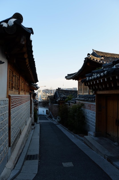 People walk on the street on MARCH 222019 in SeoulKorea Bukchon Hanok Village is a Korean traditional village in Seoul with a long history located on the top of a hill