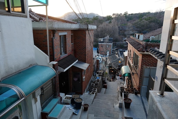 People walk on the street on MARCH 222019 in SeoulKorea Bukchon Hanok Village is a Korean traditional village in Seoul with a long history located on the top of a hill