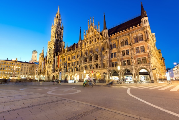 People walking at Marienplatz square and Munich city hall in night in Munich, Germany.