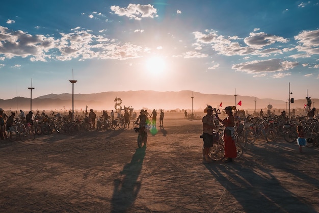 People walking towards sunset at a festival in the desert