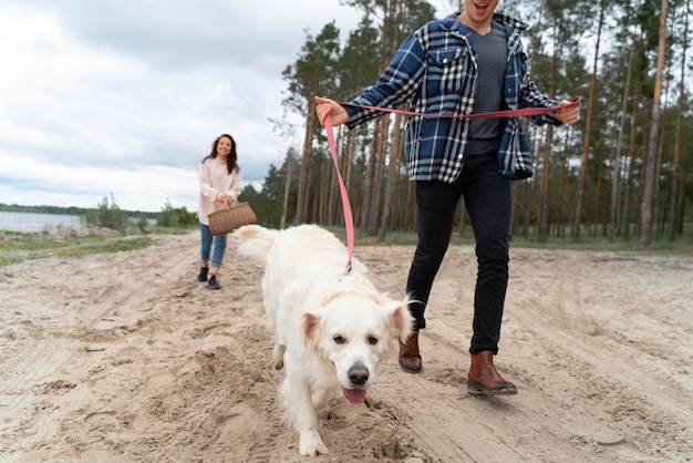 People walking with dog on beach close up