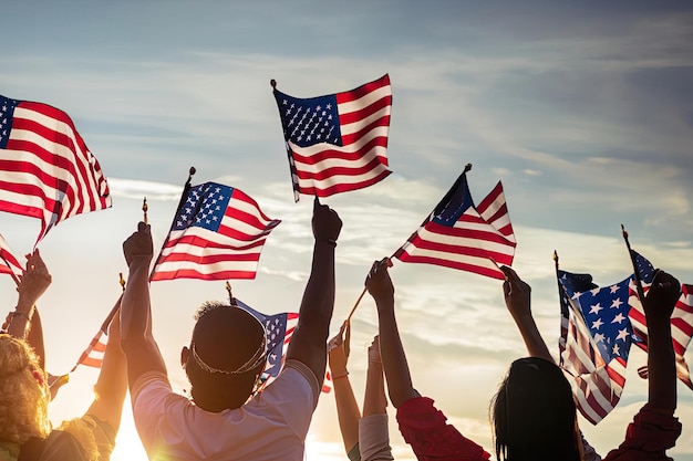 People waving flags at a sunset with the sun setting behind them