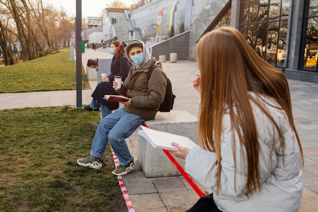 People with mask at distance from each other