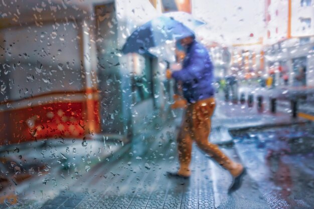 people with an umbrella in rainy days in winter season, bilbao, basque country, spain