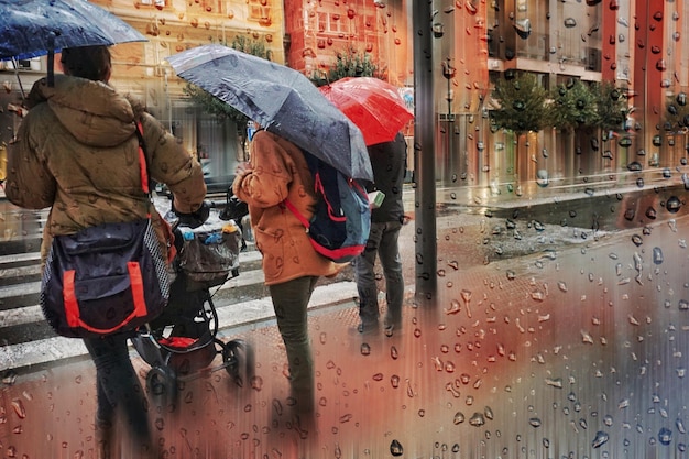 people with an umbrella in rainy days in winter season bilbao basque country spain