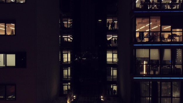 People working in an office building at night Aerial view