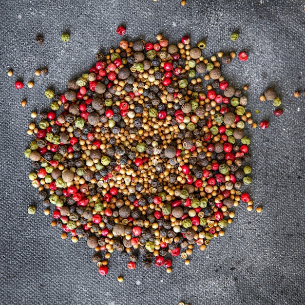 pepper peppercorn 5 spices red, black, green and white pepper, coriander food spice on the table