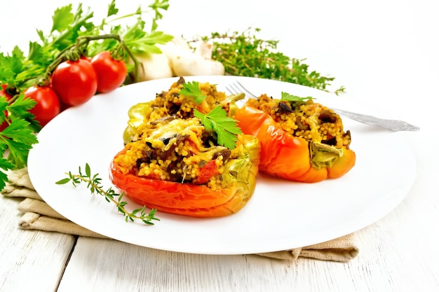 Pepper stuffed with mushrooms and couscous in plate on table