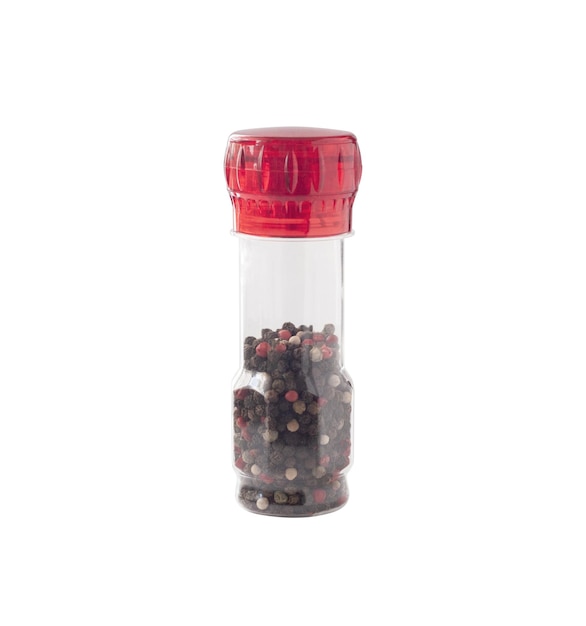 Peppercorn blend in glass transparent pepper grinder isolated on white background