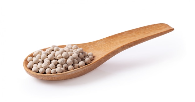 Peppercorn with wooden spoon on white background