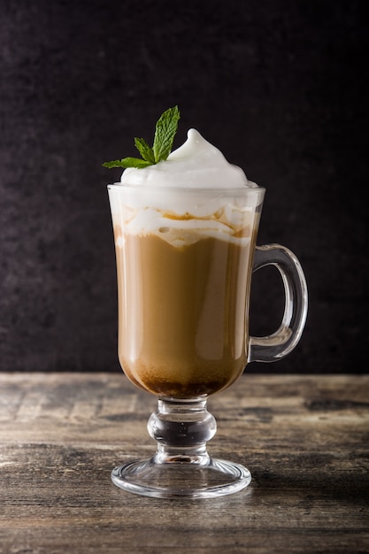 Peppermint coffee mocha for Christmas on wooden table and black.