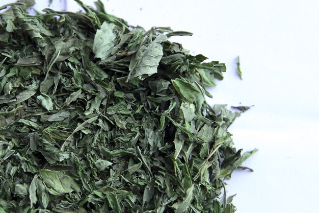 Peppermint tea green leafs  dried peppermint on white