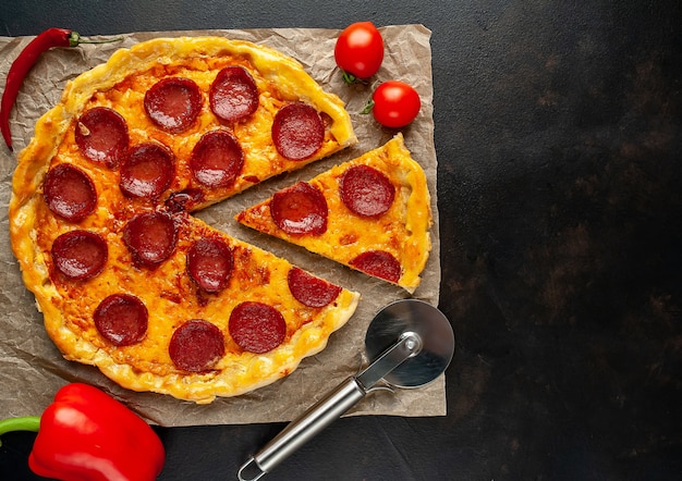 Pepperoni homemade pizza on stone background with copy space for your text.