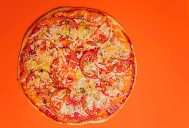 Pepperoni Pizza on an orange background above view Delicious homemade pizza top view