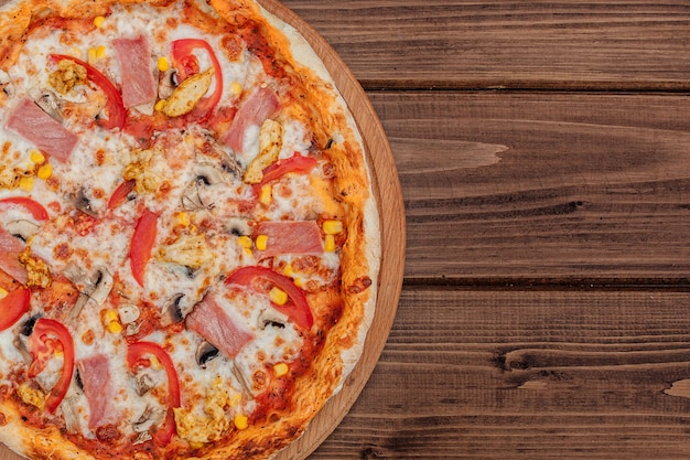 Pepperoni Pizza with Mozzarella cheese, Ham, Tomatoes, pepper, Spices . Italian pizza.