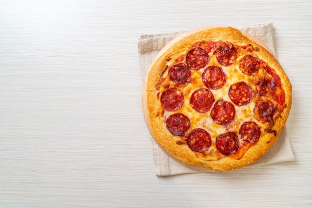 pepperoni pizza on wood tray