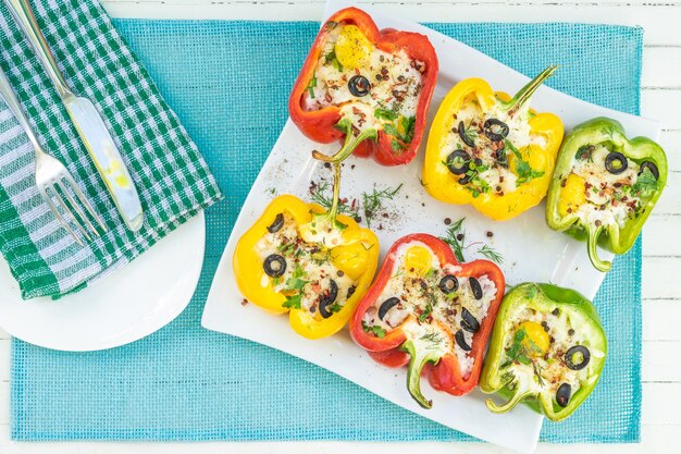 Peppers stuffed with rice and cheese vegetarian food wooden background top view