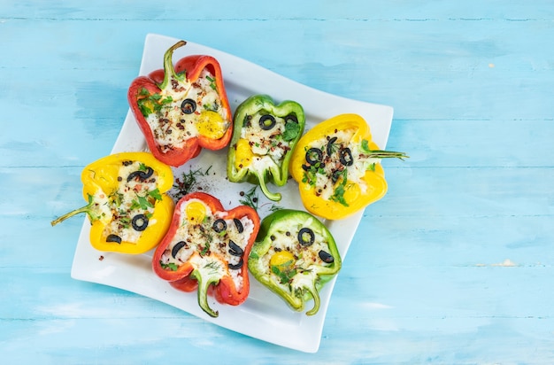 Peppers stuffed with rice and cheese vegetarian food wooden background top view