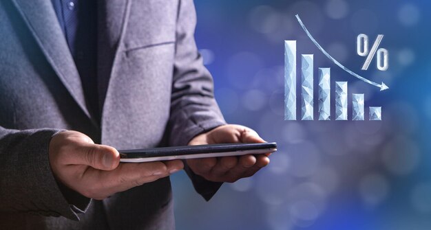 The percentage graph from the network is going down Man holding a tablet in his hand