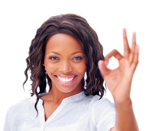 Perfect Cropped view of a pretty african american woman giving an ok sign with a smile