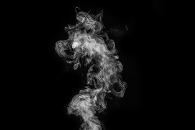 Perfect mystical curly white steam or smoke isolated on black background. Abstract background fog or smog, design element for Halloween, layout for collages.