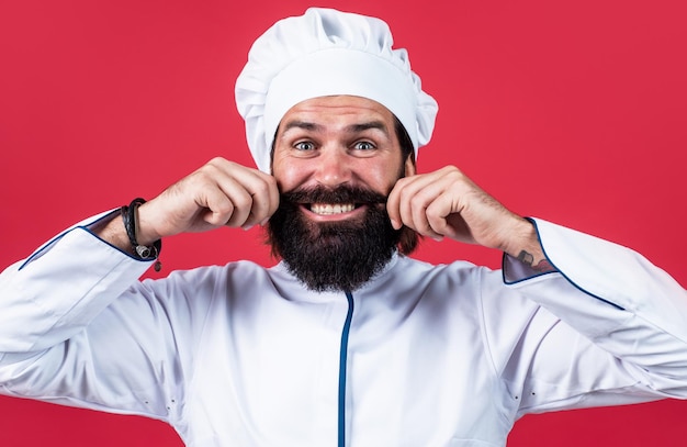 Perfect shape professional restaurant cook baking skilled baker use kitchen utensils for cooking male chef in hat prepare healthy meal handsome man with beard and moustache cooking food