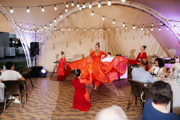 Performance of a show-ballet of a dance group of actors in bright costumes