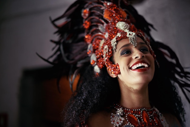 Performing live brings a smile to all Cropped shot of a beautiful samba dancer wearing a headdress