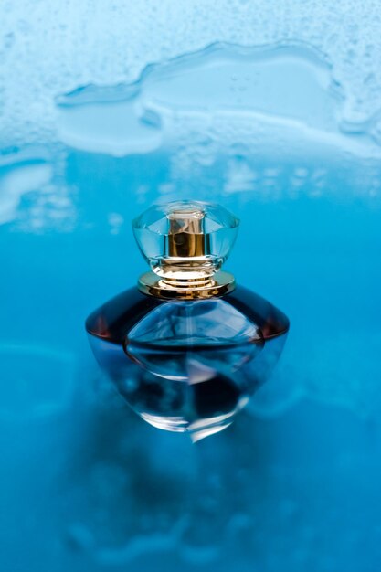 Perfume bottle under blue water fresh sea coastal scent as glamour fragrance and eau de parfum product as holiday gift luxury beauty spa brand present