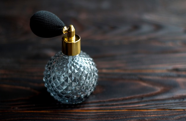 Perfume bottle on dark table.