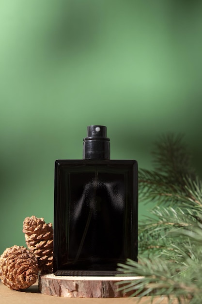 Perfume bottle and fir branches and pine cones Concept of expensive perfume and cosmetics Floral fragrance for women Perfume spray