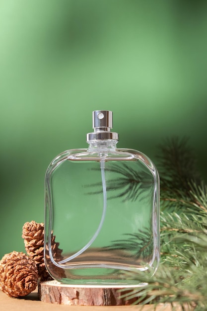 Perfume bottle and fir branches and pine cones Concept of expensive perfume and cosmetics Floral fragrance for women Perfume spray