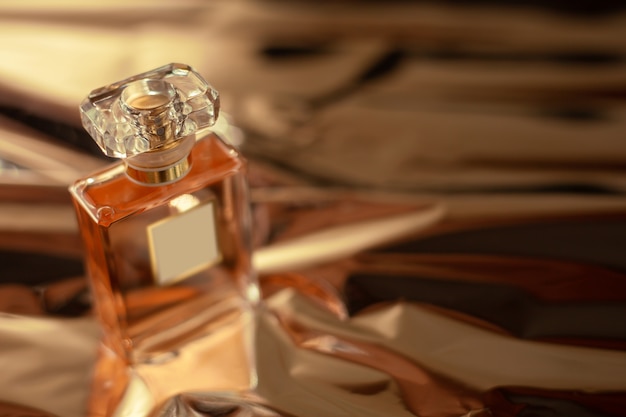 Perfume bottle on gold surface