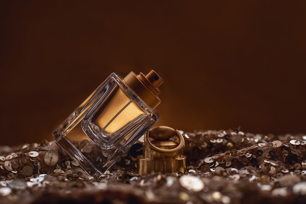 Perfume bottle on golden bokeh .