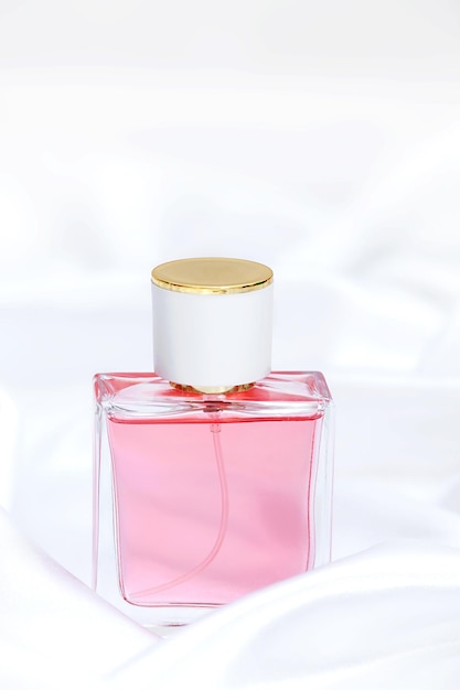 Perfume bottle on a silk background. vertical photo