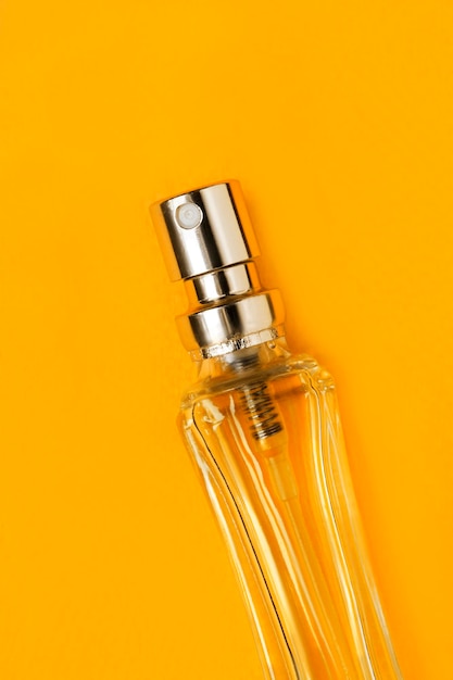 Photo perfume bottle on yellow