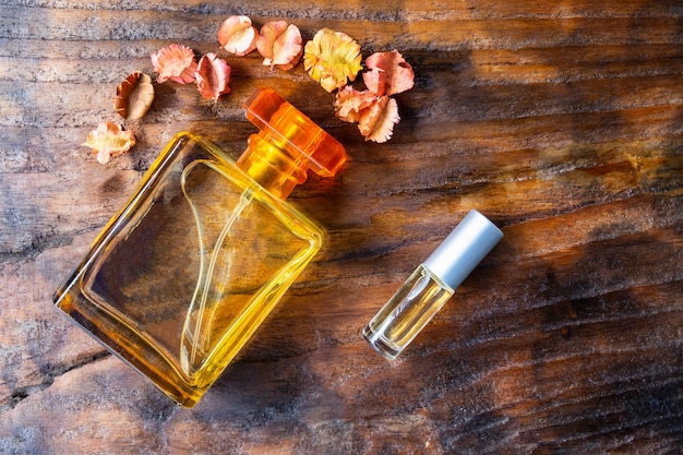 Perfume and perfume bottles on wooden background