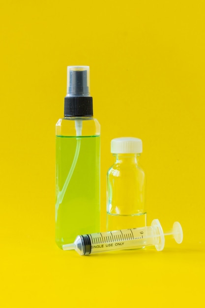 Perfume, syringes and perfume making equipment Isolated on a yellow background.