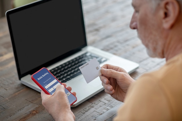 Periodical payments. A man paying in internet using his credit card