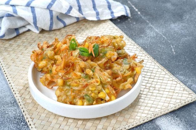 perkedel  jagung or bakwan jagung, corn fritters served on a white plate.