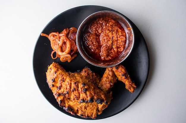 Perri Perri grilled Chicken wwith chili sauce served in a dish isolated top view of bangladesh food