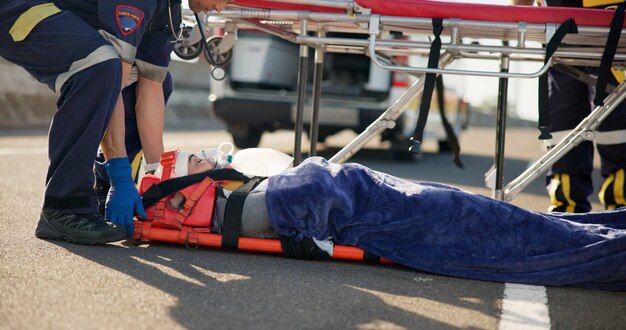 Photo person accident and emergency on street with stretcher for support medical response to trauma with oxygen safety first aid or health insurance or air mask for breath on road ems or crisis