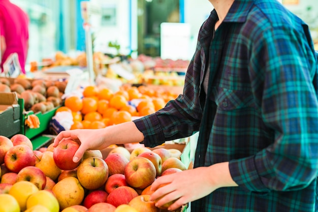 Person buying fruits and vegetables