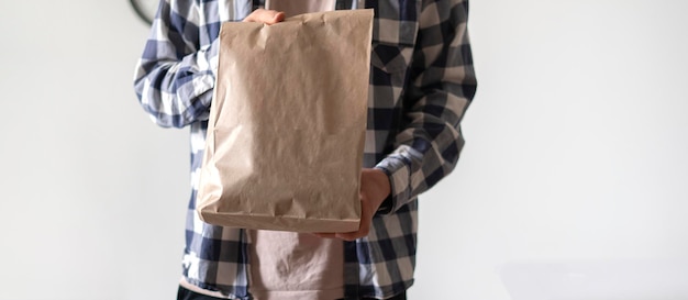 A person carrying paper package with delivered food