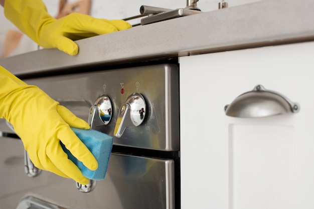 Person cleaning the kitchen with gloves