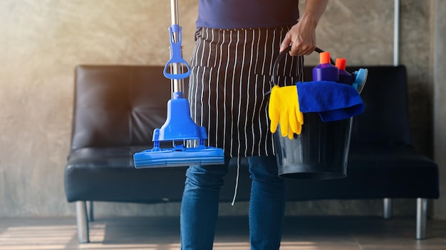 Person cleaning the room cleaning staff standing holding a bucket of cleaning equipment Cleaning staff Maintaining cleanliness in the organization