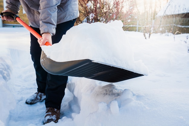 Person clearing snow with shovel